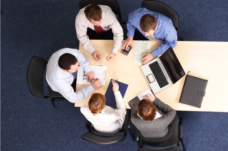 business people at table looking at computer